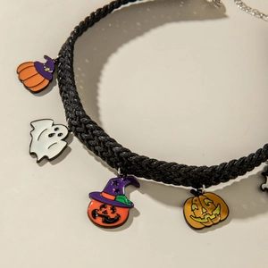 Detail of Halloween choker with enamel ghost and pumpkin pendants on black woven cord