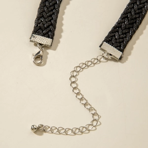 Close-up of black braided choker necklace with silver-tone lobster clasp and extender chain