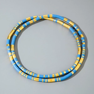 Macro view of blue and gold disc beads on a double layered African style snake necklace