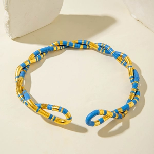 Macro detail of twisted open choker necklace in blue and gold with textured rings