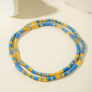 Exaggerated snake-style necklace with blue clay beads and gold-tone spacers in a double loop