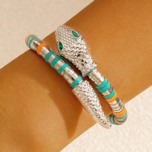 Detail of snake necklace featuring silver scales, green eyes, and vibrant tricolor coils