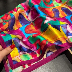 Detail of 100% mulberry silk scarf featuring abstract colorful oil painting patterns