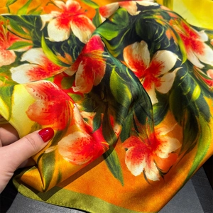 Orange silk square scarf with vibrant lily floral prints and satin edges for women
