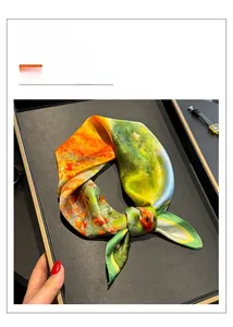 Detailed macro view of oil painting style 100% mulberry silk square scarf in a black tray