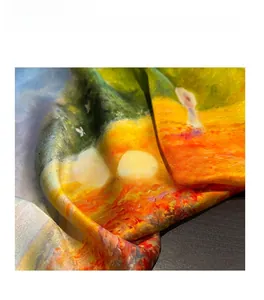 Detailed view of the smooth texture and vibrant oil painting print on a 100% silk scarf