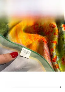 Detailed close-up of 100% mulberry silk scarf edge with vibrant floral print pattern