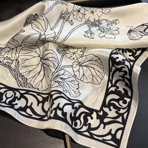 Detailed macro view of vintage butterfly silk scarf with intricate floral print texture