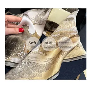 Detail of silk scarf with traditional landscape print showing soft texture and sheen