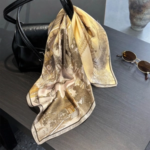 Vintage silk square scarf with architectural print tied to a leather handbag
