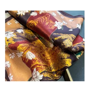 Detailed shot of vintage silk scarf showing silk satin texture and landscape pattern