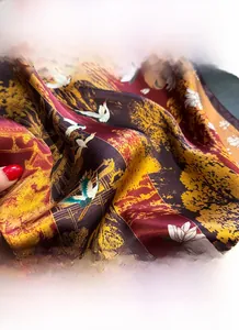 Detail of silk scarf showing traditional crane prints and dense overlock stitching edge