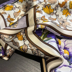 Close-up of printed silk square scarf with vintage floral patterns and smooth texture