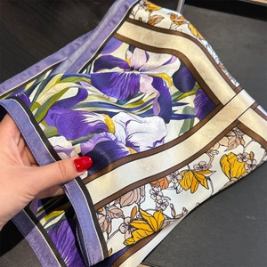 Elegant 53cm floral silk scarf with iris print and satin finish on dark wood background