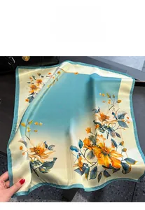 Detailed view of floral print silk scarf featuring elegant blue and orange patterns