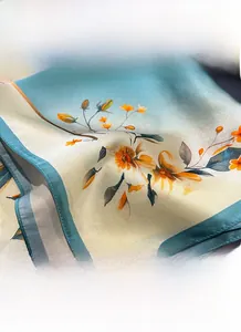 Detail view of fine stitching on silk scarf with elegant orange floral prints