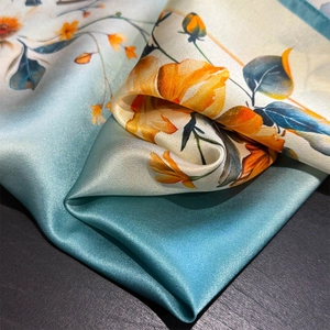 Detailed macro view of vibrant floral print on premium smooth satin silk scarf