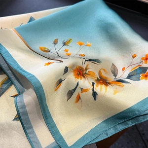 Elegant silk scarf featuring green edges and center floral pattern on a dark background