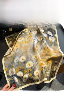 Detail of artistic oil painting silk scarf with white floral prints and yellow borders