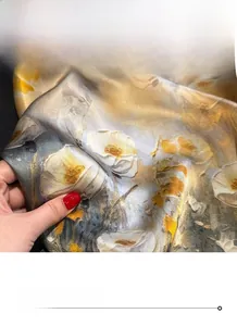 Detailed view of 100% mulberry silk scarf showing oil painting floral texture and rolled hem