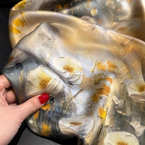 Macro detail of abstract floral pattern on 100% mulberry silk scarf showing soft texture