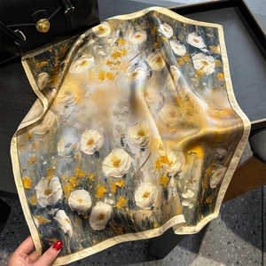 Silk oil painting scarf with white flowers and ginger tones in a textured flat lay