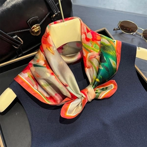 53cm mulberry silk scarf with colorful floral print and luxurious sheen on a hanger