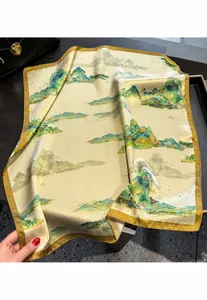 Macro detail of silk square scarf featuring traditional green mountain landscape print