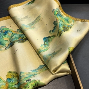 Detailed close-up of silk square scarf featuring traditional landscape painting