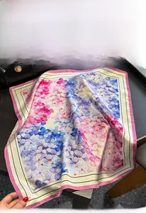 Detail of 100% mulberry silk scarf with vintage floral hydrangea print on dark table