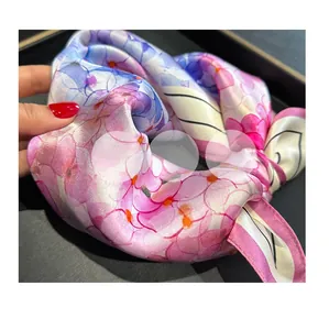 Close-up of soft floral mulberry silk scarf showing smooth texture and drape