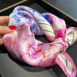 Detailed view of 100% mulberry silk scarf with pink and purple floral gradient patterns