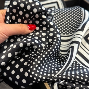 Elegant black and white polka dot silk scarf with striped borders and satin finish