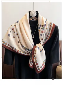 Detail of a vintage floral silk scarf with cream base and brown border on a model