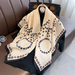 Retro double-sided scarf with floral patterns and black contrast borders on leather sofa