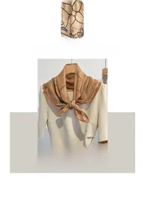Detail of vintage chain print on brown cotton linen square scarf draped over a shoulder