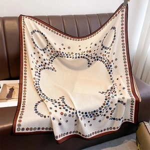 Vintage double-sided floral silk scarf draped on a brown leather sofa for styling