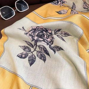 Elegant floral print scarf in yellow and beige with detailed rose patterns and twill texture