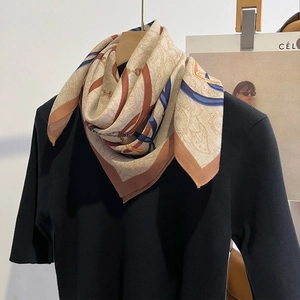 Elegant 68cm square silk scarf with vintage chain print on a black knit top