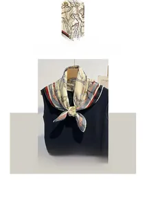 Dettaglio di sciarpa beige in cotone e lino con stampa a catena vintage sul collo