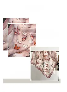 Detail view of pink gradient scarf with butterfly print and neat machine-rolled edges