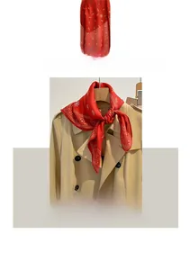 Detail of red paisley cotton linen scarf with embroidery styled on a khaki trench coat