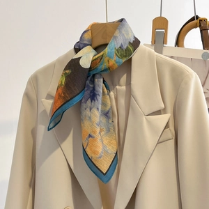 Abstract oil painting style floral silk scarf styled on a beige blazer for women
