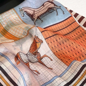 Close-up of horse print scarf showing soft texture and vintage equestrian pattern