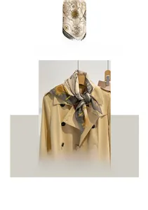 Detail of nautical print cotton linen neck scarf tied on a beige trench coat collar