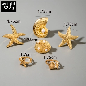 Detailed size and weight view of 6-piece gold starfish and seashell ring set