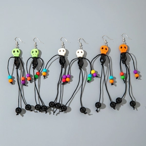 Detailed set of colorful Halloween tassel earrings featuring skull beads and black weaving