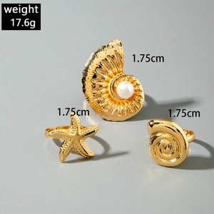 Detail view of gold starfish and shell rings with weight and size specifications