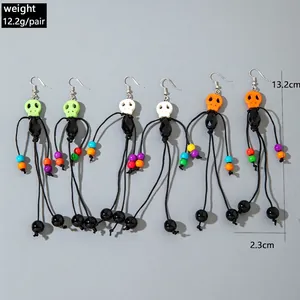 Halloween tassel bead skull earrings in green, white, and orange beaded drop style