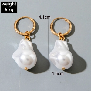 Detailed view of baroque pearl earrings with golden hoops and size measurements